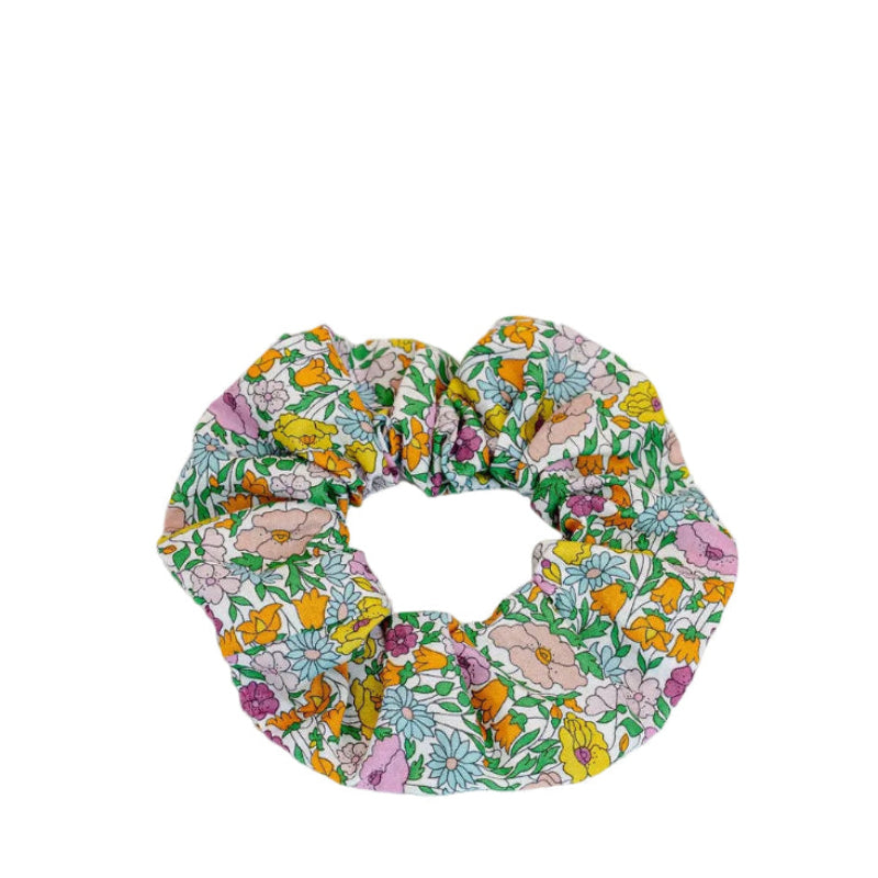 Liberty of London | Poppy Forest A Yellow Fabric Print Scrunchie.&nbsp; Add a touch of timeless elegance to your hairstyle with this iconic Liberty of London Tana Lawn cotton print scrunchie.&nbsp;This ditsy, meadow floral&nbsp; in pink, yellow and light blue is the smaller version of the iconic Poppy &amp; Daisy which was first printed in around 1917.