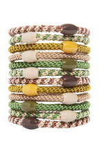 Stack of colorful woven bracelets on a white background